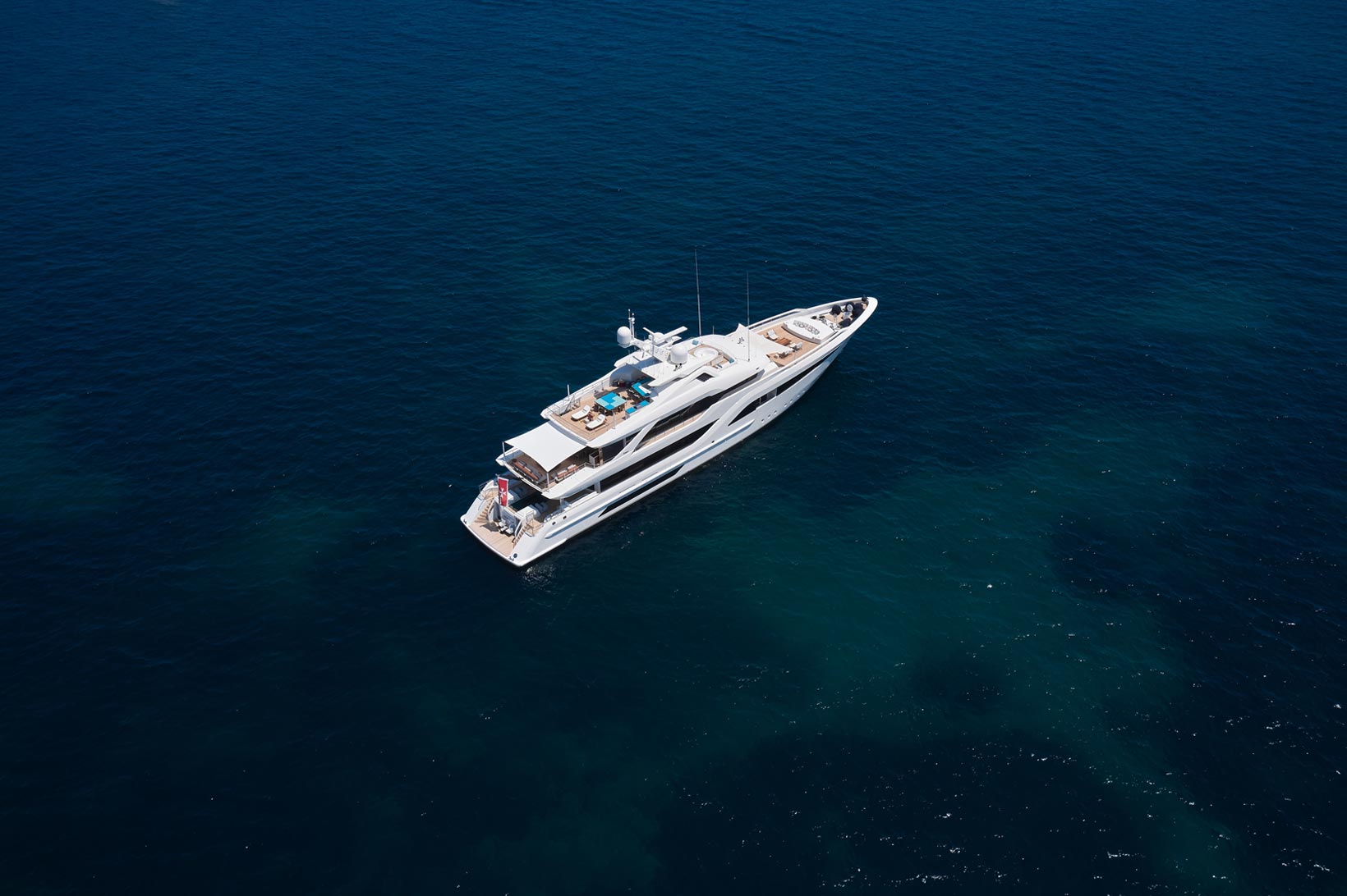 An image of a yacht sailing in sea.
